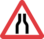 Road narrows on both sides